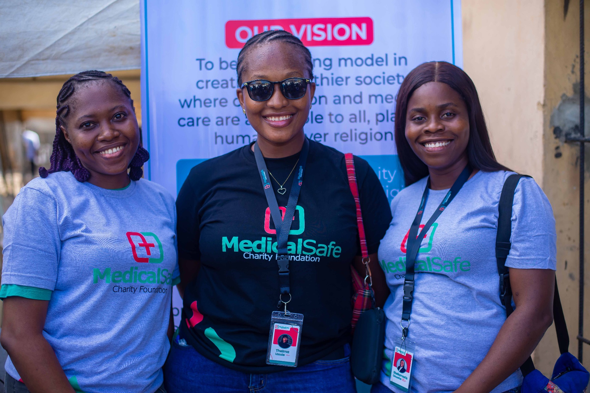 Volunteers at the Our Vision banner