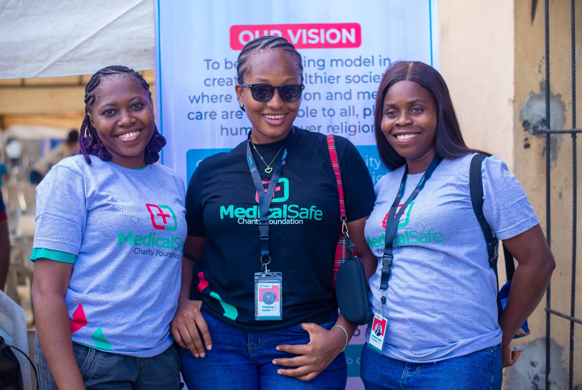 Volunteers posing at vision banner